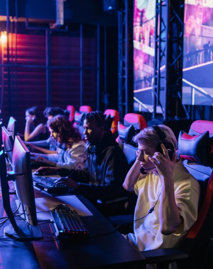 Focused gamers in a high-tech arena compete intensely, showcasing esports fervor.